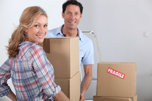 Movers handling furniture in a narrow Lewisham stairwell